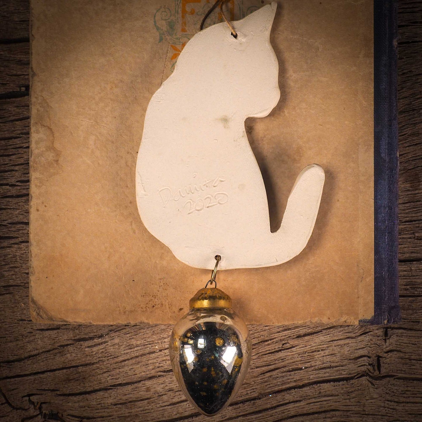 An original Christmas Holiday tree ornament ceramic cat, handmade by Idania Salcido the artist behind Danita Art. Glazed carved sgraffito stoneware, hand painted and decorated, it has a beautiful vintage glass tree ornament to adorn a unique holiday gift for family and friends. Christmas gift for animal and pet lovers.