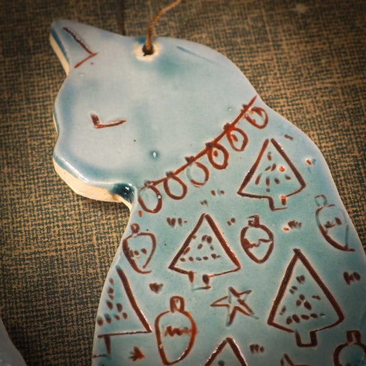 An original Christmas Holiday tree ornament ceramic cat, handmade by Idania Salcido the artist behind Danita Art. Glazed carved sgraffito stoneware, hand painted and decorated, it has a beautiful vintage glass tree ornament to adorn a unique holiday gift for family and friends. Christmas gift for animal and pet lovers.