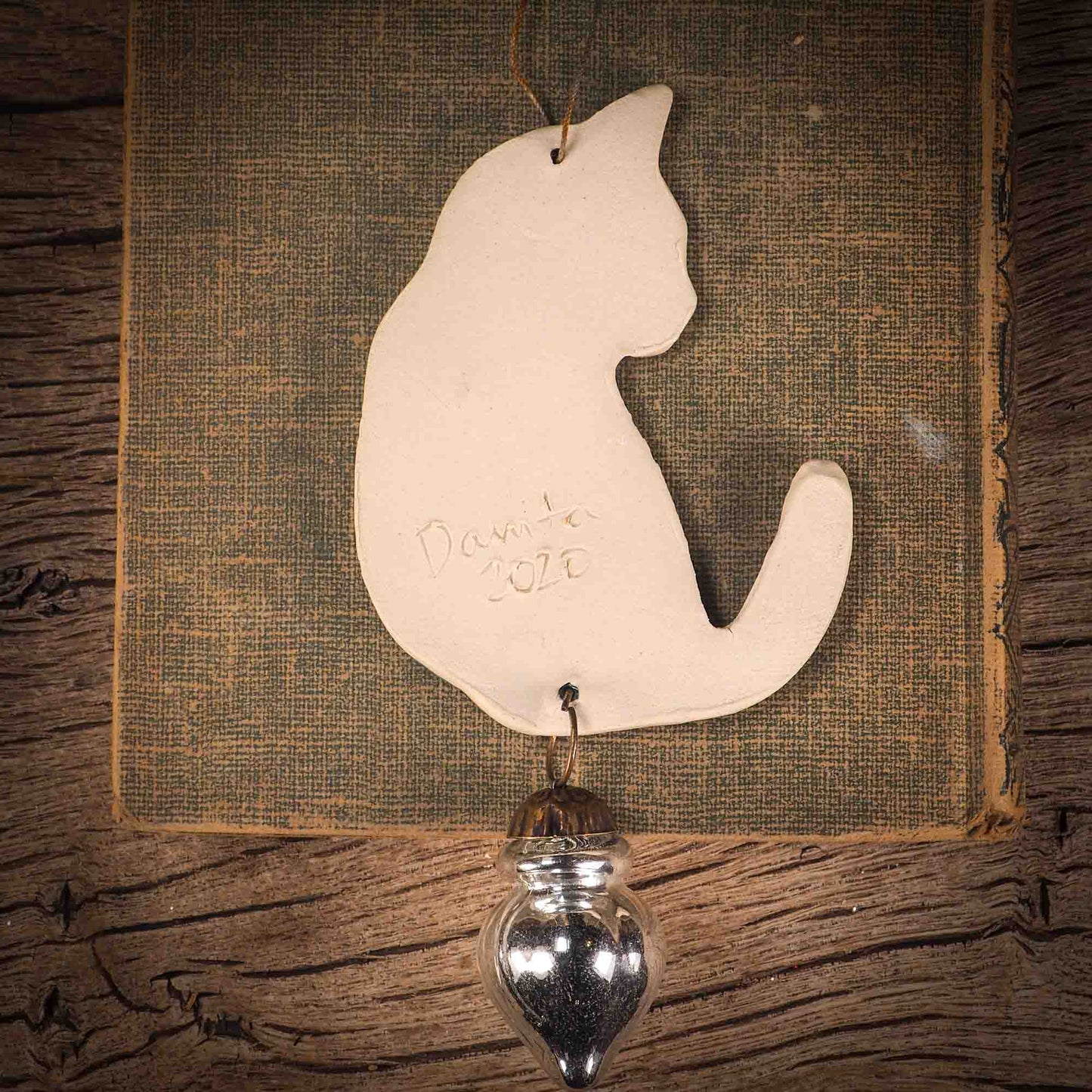 An original Christmas Holiday tree ornament ceramic cat, handmade by Idania Salcido the artist behind Danita Art. Glazed carved sgraffito stoneware, hand painted and decorated, it has a beautiful vintage glass tree ornament to adorn a unique holiday gift for family and friends. Christmas gift for animal and pet lovers.