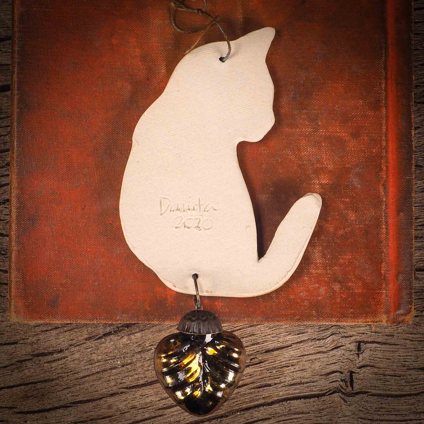 An original Christmas Holiday tree ornament ceramic cat, handmade by Idania Salcido the artist behind Danita Art. Glazed carved sgraffito stoneware, hand painted and decorated, it has a beautiful vintage glass tree ornament to adorn a unique holiday gift for family and friends. Christmas gift for animal and pet lovers.