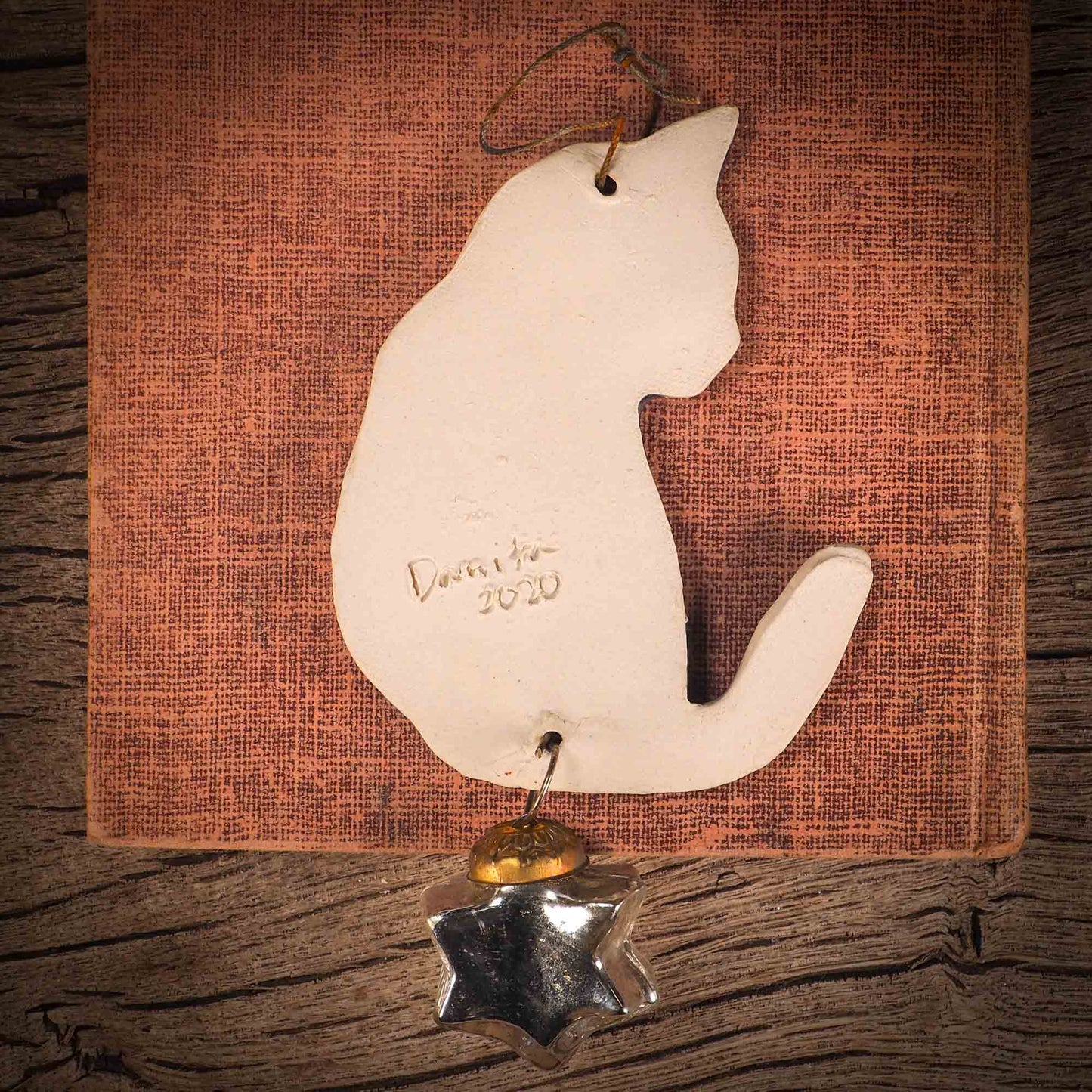 An original Christmas Holiday tree ornament ceramic cat, handmade by Idania Salcido the artist behind Danita Art. Glazed carved sgraffito stoneware, hand painted and decorated, it has a beautiful vintage glass tree ornament to adorn a unique holiday gift for family and friends. Christmas gift for animal and pet lovers.