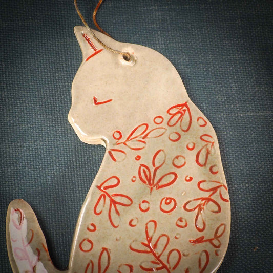 An original Christmas Holiday tree ornament ceramic cat, handmade by Idania Salcido the artist behind Danita Art. Glazed carved sgraffito stoneware, hand painted and decorated, it has a beautiful vintage glass tree ornament to adorn a unique holiday gift for family and friends. Christmas gift for animal and pet lovers.