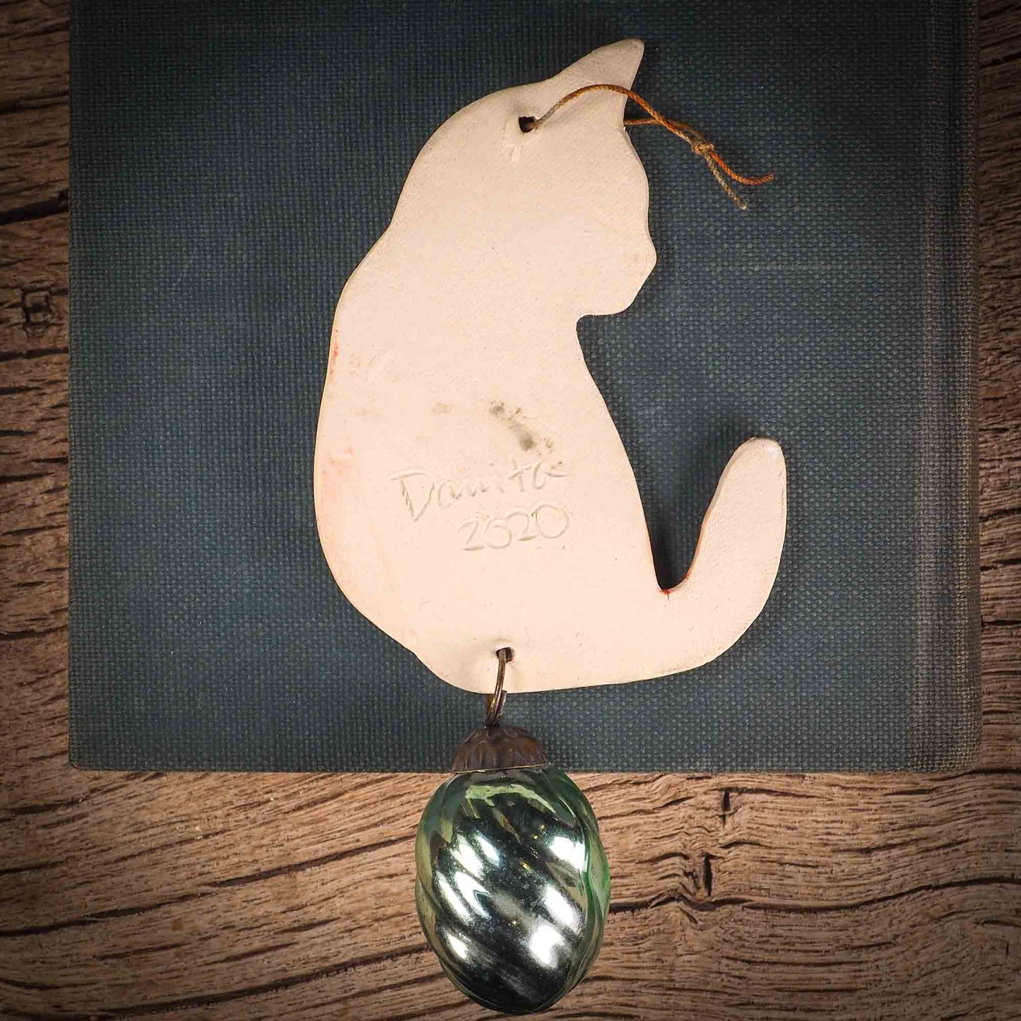 An original Christmas Holiday tree ornament ceramic cat, handmade by Idania Salcido the artist behind Danita Art. Glazed carved sgraffito stoneware, hand painted and decorated, it has a beautiful vintage glass tree ornament to adorn a unique holiday gift for family and friends. Christmas gift for animal and pet lovers.