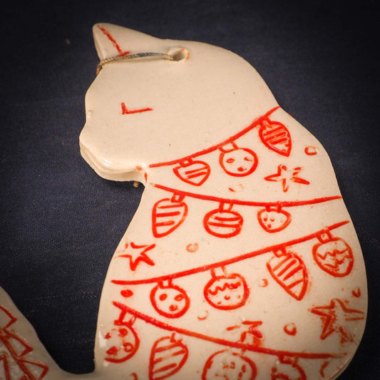 An original Christmas Holiday tree ornament ceramic cat, handmade by Idania Salcido the artist behind Danita Art. Glazed carved sgraffito stoneware, hand painted and decorated, it has a beautiful vintage glass tree ornament to adorn a unique holiday gift for family and friends. Christmas gift for animal and pet lovers.