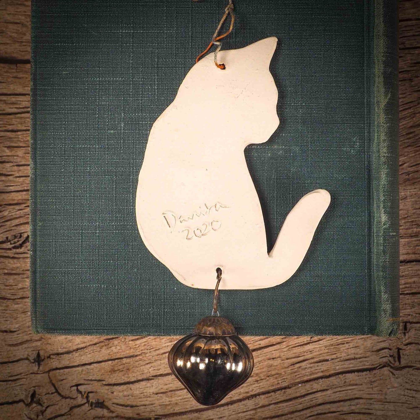 An original Christmas Holiday tree ornament ceramic cat, handmade by Idania Salcido the artist behind Danita Art. Glazed carved sgraffito stoneware, hand painted and decorated, it has a beautiful vintage glass tree ornament to adorn a unique holiday gift for family and friends. Christmas gift for animal and pet lovers.