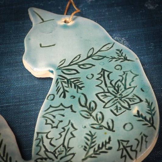 An original Christmas Holiday tree ornament ceramic cat, handmade by Idania Salcido the artist behind Danita Art. Glazed carved sgraffito stoneware, hand painted and decorated, it has a beautiful vintage glass tree ornament to adorn a unique holiday gift for family and friends. Christmas gift for animal and pet lovers.