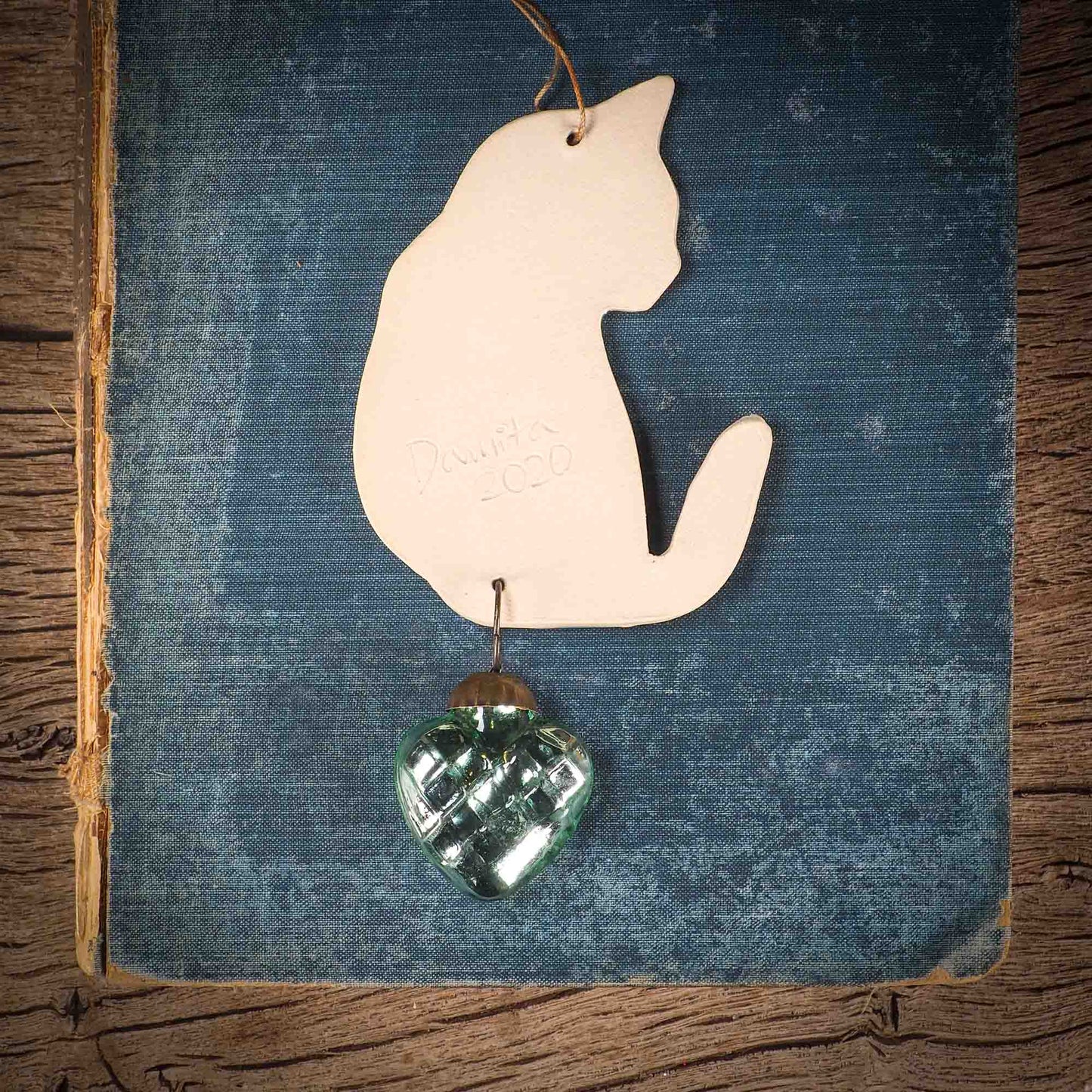 An original Christmas Holiday tree ornament ceramic cat, handmade by Idania Salcido the artist behind Danita Art. Glazed carved sgraffito stoneware, hand painted and decorated, it has a beautiful vintage glass tree ornament to adorn a unique holiday gift for family and friends. Christmas gift for animal and pet lovers.