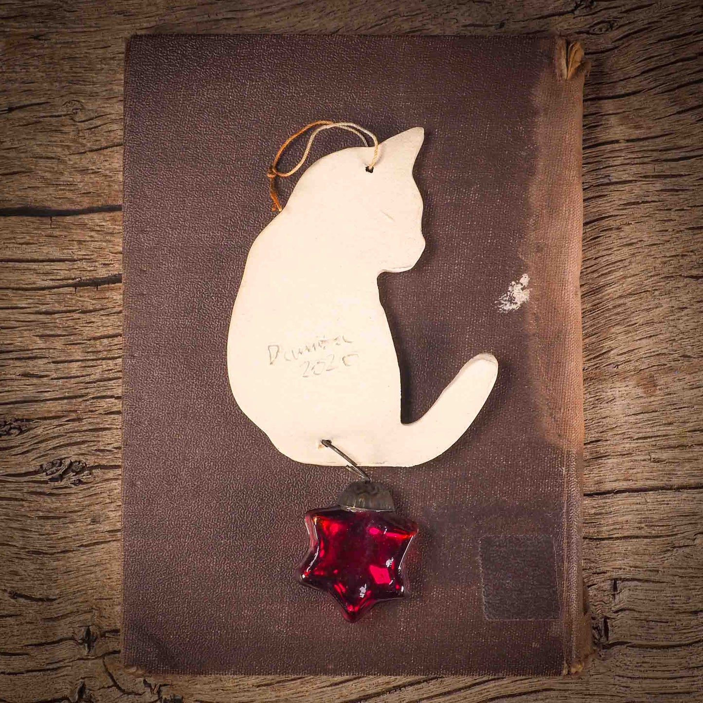 An original Christmas Holiday tree ornament ceramic cat, handmade by Idania Salcido the artist behind Danita Art. Glazed carved sgraffito stoneware, hand painted and decorated, it has a beautiful vintage glass tree ornament to adorn a unique holiday gift for family and friends. Christmas gift for animal and pet lovers.