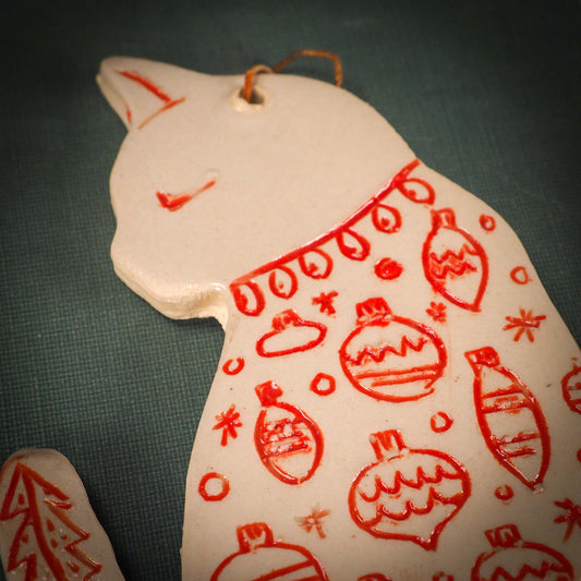 An original Christmas Holiday tree ornament ceramic cat, handmade by Idania Salcido the artist behind Danita Art. Glazed carved sgraffito stoneware, hand painted and decorated, it has a beautiful vintage glass tree ornament to adorn a unique holiday gift for family and friends. Christmas gift for animal and pet lovers.