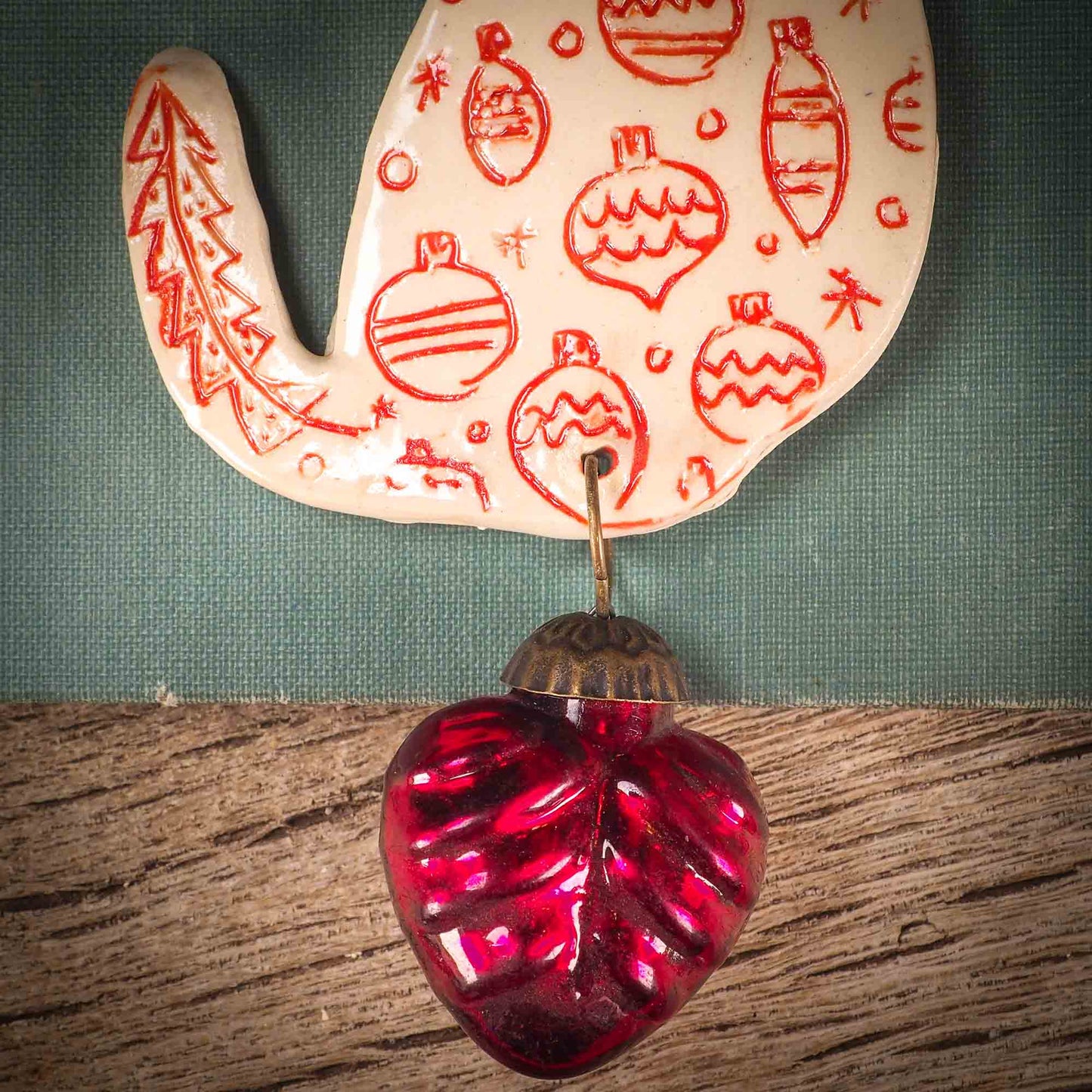 An original Christmas Holiday tree ornament ceramic cat, handmade by Idania Salcido the artist behind Danita Art. Glazed carved sgraffito stoneware, hand painted and decorated, it has a beautiful vintage glass tree ornament to adorn a unique holiday gift for family and friends. Christmas gift for animal and pet lovers.