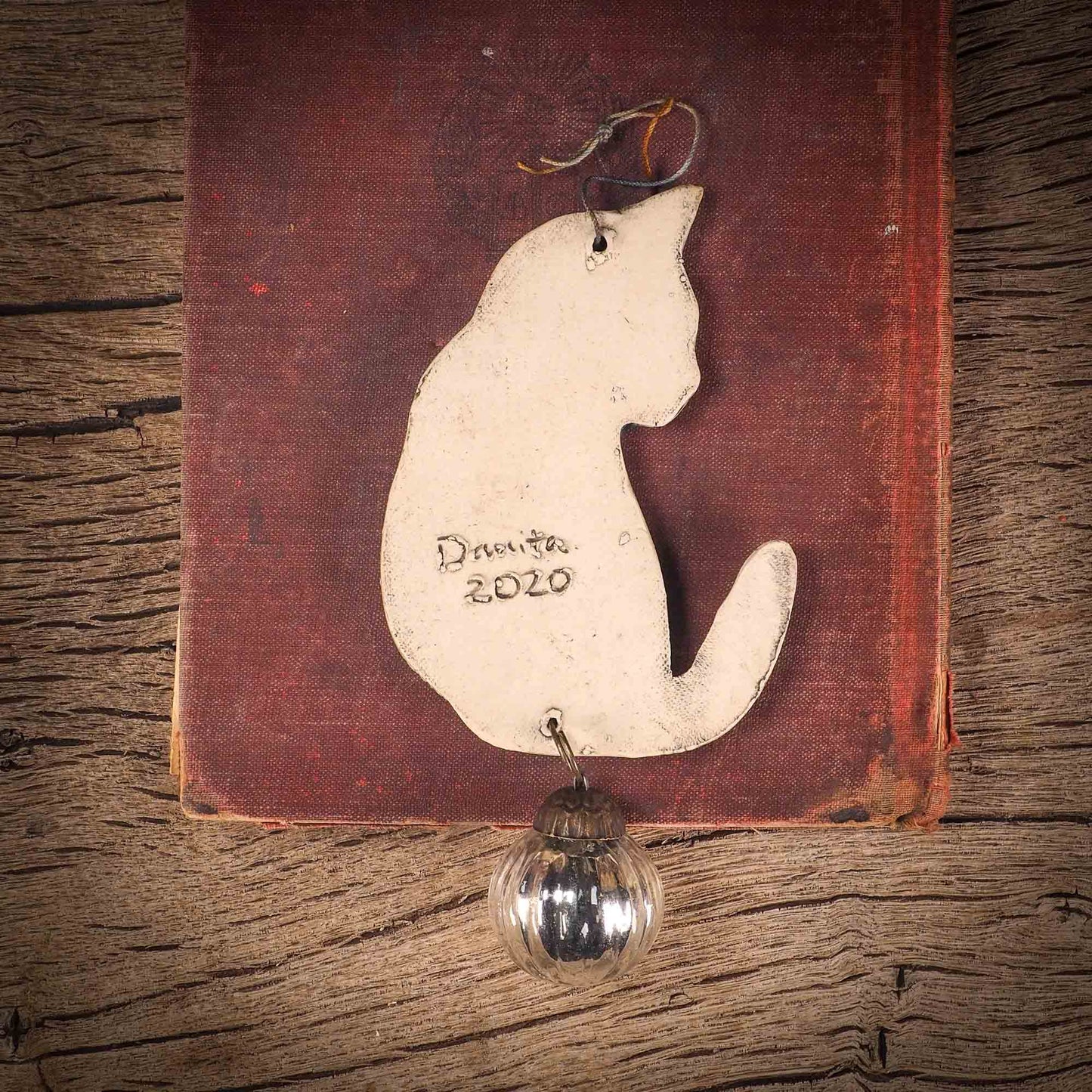 An original Christmas Holiday tree ornament ceramic cat, handmade by Idania Salcido the artist behind Danita Art. Glazed carved sgraffito stoneware, hand painted and decorated, it has a beautiful vintage glass tree ornament to adorn a unique holiday gift for family and friends. Christmas gift for animal and pet lovers.