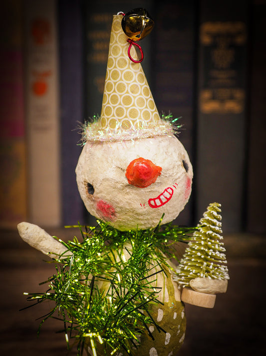 Adorable handmade spun cotton Art Doll Christmas tree ornament by Idania Salcido, the artist by Danita Art. Hand painted by the artist holiday figurine with paper hat with tinsel and vintage style garlands and a tiny Christmas tree. Hang this handmade ornament from your Christmas tree or use as Holiday decoration.