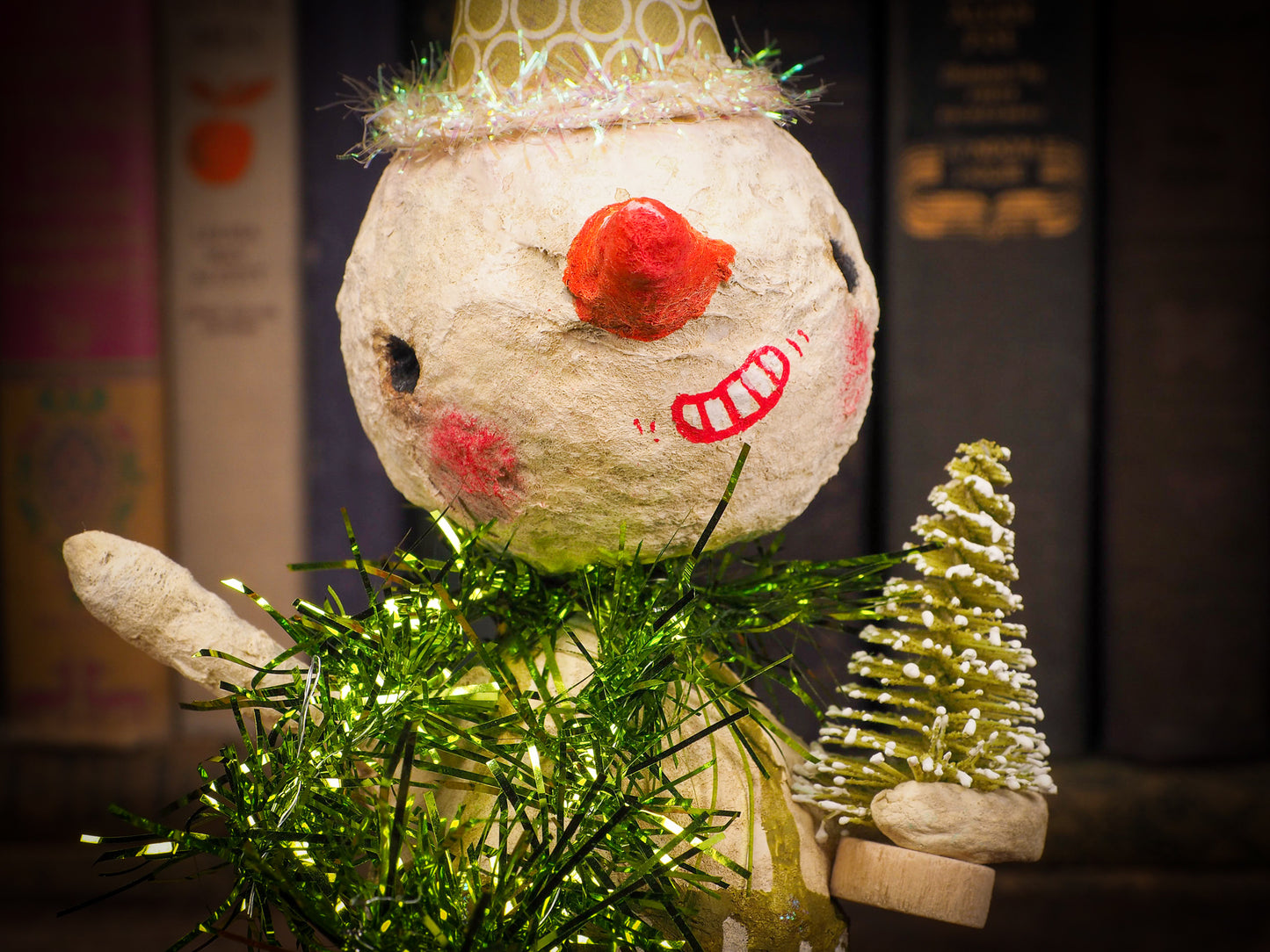 Adorable handmade spun cotton Art Doll Christmas tree ornament by Idania Salcido, the artist by Danita Art. Hand painted by the artist holiday figurine with paper hat with tinsel and vintage style garlands and a tiny Christmas tree. Hang this handmade ornament from your Christmas tree or use as Holiday decoration.