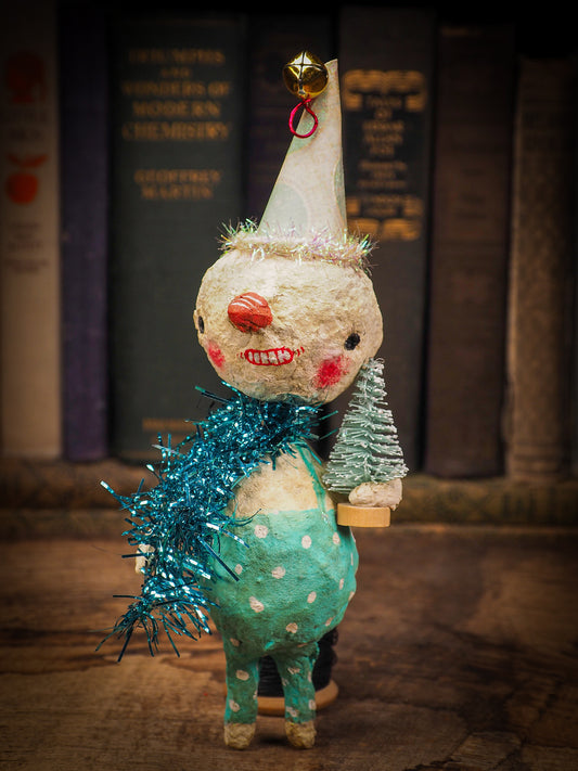 Adorable handmade spun cotton Art Doll Christmas tree ornament by Idania Salcido, the artist by Danita Art. Hand painted by the artist holiday figurine with paper hat with tinsel and vintage style garlands and a tiny Christmas tree. Hang this handmade ornament from your Christmas tree or use as Holiday decoration.