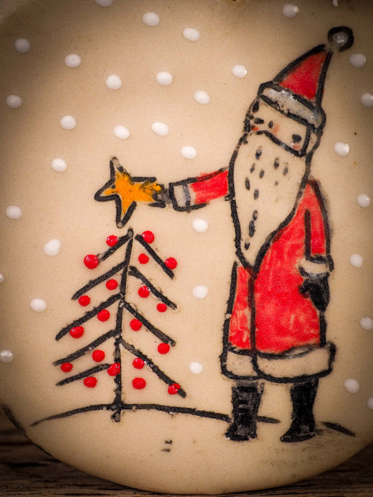 An original Christmas Holiday tree round glazed ceramic ornament handmade by Idania Salcido, the artist behind Danita Art. Glazed carved sgraffito stoneware, hand painted and decorated, it is illustrated by hand with winter scenes with snowmen, Christmas trees, Santa Claus, snow balls and winter themes.