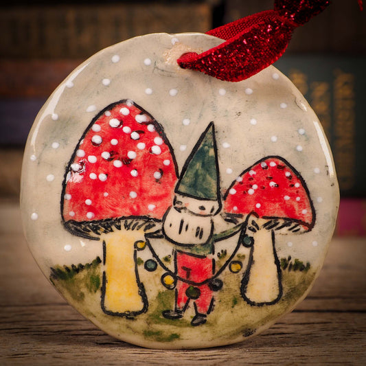 An original Christmas Holiday tree round glazed ceramic ornament handmade by Idania Salcido, the artist behind Danita Art. Glazed carved sgraffito stoneware, hand painted and decorated, it is illustrated by hand with winter scenes with snowmen, Christmas trees, Santa Claus, snow balls and winter themes.