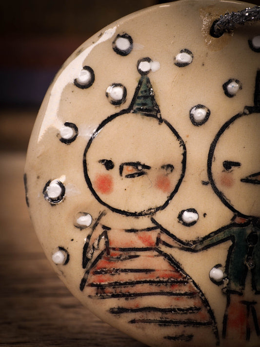 An original Christmas Holiday tree round glazed ceramic ornament handmade by Idania Salcido, the artist behind Danita Art. Glazed carved sgraffito stoneware, hand painted and decorated, it is illustrated by hand with winter scenes with snowmen, Christmas trees, Santa Claus, snow balls and winter themes.