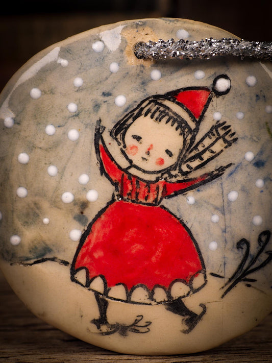 An original Christmas Holiday tree round glazed ceramic ornament handmade by Idania Salcido, the artist behind Danita Art. Glazed carved sgraffito stoneware, hand painted and decorated, it is illustrated by hand with winter scenes with snowmen, Christmas trees, Santa Claus, snow balls and winter themes.