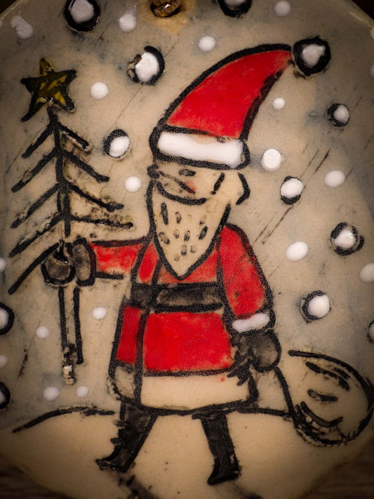 An original Christmas Holiday tree round glazed ceramic ornament handmade by Idania Salcido, the artist behind Danita Art. Glazed carved sgraffito stoneware, hand painted and decorated, it is illustrated by hand with winter scenes with snowmen, Christmas trees, Santa Claus, snow balls and winter themes.