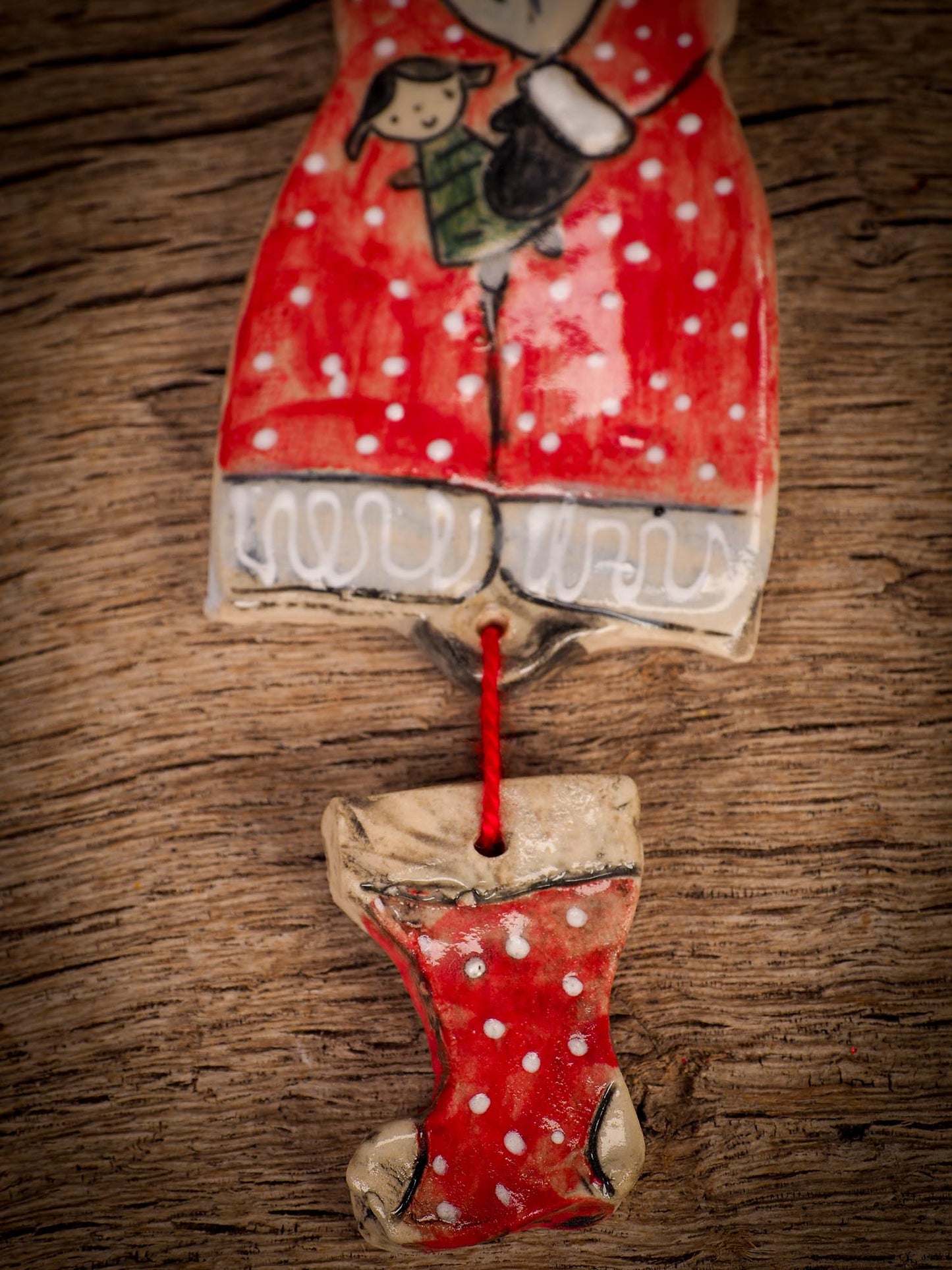 An original Christmas Holiday tree round glazed ceramic ornament handmade by Idania Salcido, the artist behind Danita Art. Glazed carved sgraffito stoneware, hand painted and decorated, it is illustrated by hand with snowmen, Christmas trees, Santa Claus, angels and snow balls and winter themes.