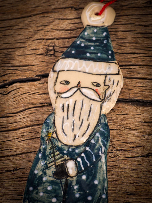 An original Christmas Holiday tree round glazed ceramic ornament handmade by Idania Salcido, the artist behind Danita Art. Glazed carved sgraffito stoneware, hand painted and decorated, it is illustrated by hand with snowmen, Christmas trees, Santa Claus, angels and snow balls and winter themes.