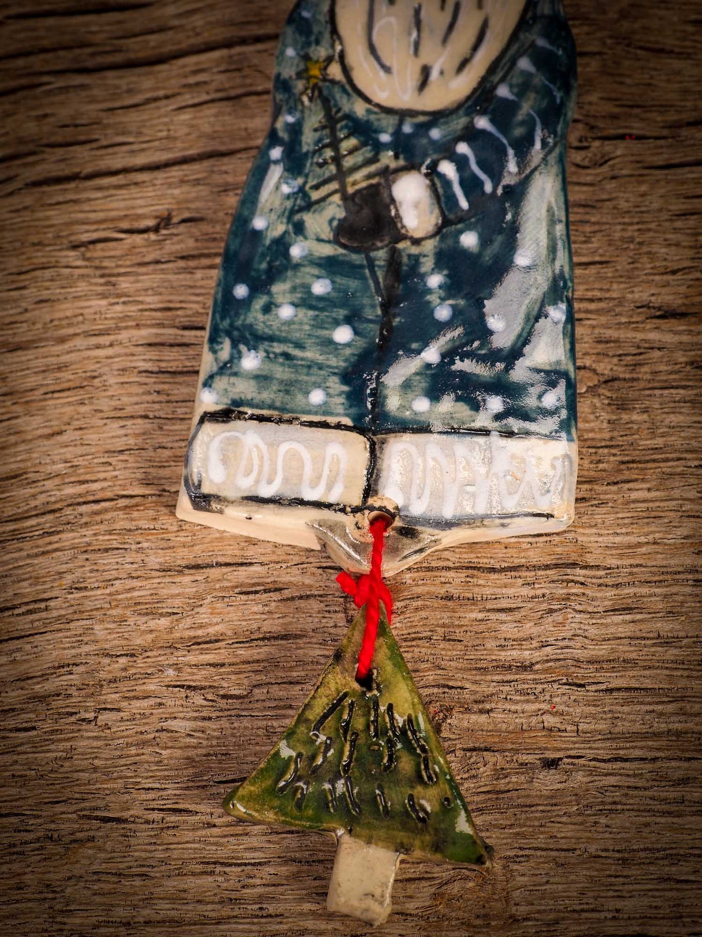 An original Christmas Holiday tree round glazed ceramic ornament handmade by Idania Salcido, the artist behind Danita Art. Glazed carved sgraffito stoneware, hand painted and decorated, it is illustrated by hand with snowmen, Christmas trees, Santa Claus, angels and snow balls and winter themes.