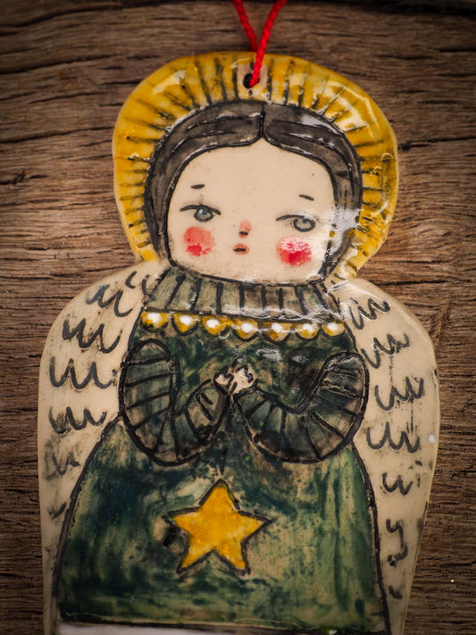 An original Christmas Holiday tree round glazed ceramic ornament handmade by Idania Salcido, the artist behind Danita Art. Glazed carved sgraffito stoneware, hand painted and decorated, it is illustrated by hand with snowmen, Christmas trees, Santa Claus, angels and snow balls and winter themes.