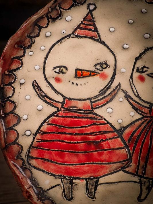 An original Christmas Holiday cake dinner plate round glazed ceramic dinnerware handmade by Idania Salcido, the artist behind Danita Art. Glazed carved sgraffito stoneware, hand painted and decorated, it is illustrated by hand with snowmen, Christmas trees, Santa Claus, angels and snow balls and winter themes.