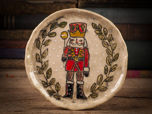 An original Christmas Holiday cake dinner dessert plate round glazed ceramic dinnerware handmade by Idania Salcido, the artist behind Danita Art. Glazed carved sgraffito stoneware, hand painted and decorated, it is illustrated by hand with snowmen, Christmas trees, Santa Claus, angels and snow balls and winter themes.