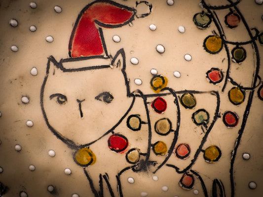 An original Christmas Holiday cake dinner dessert plate round glazed ceramic dinnerware handmade by Idania Salcido, the artist behind Danita Art. Glazed carved sgraffito stoneware, hand painted and decorated, it is illustrated by hand with snowmen, Christmas trees, Santa Claus, angels and snow balls and winter themes.