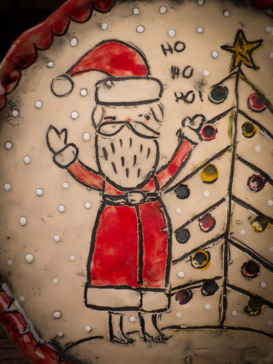 An original Christmas Holiday cake dinner dessert plate round glazed ceramic dinnerware handmade by Idania Salcido, the artist behind Danita Art. Glazed carved sgraffito stoneware, hand painted and decorated, it is illustrated by hand with snowmen, Christmas trees, Santa Claus, angels and snow balls and winter themes.