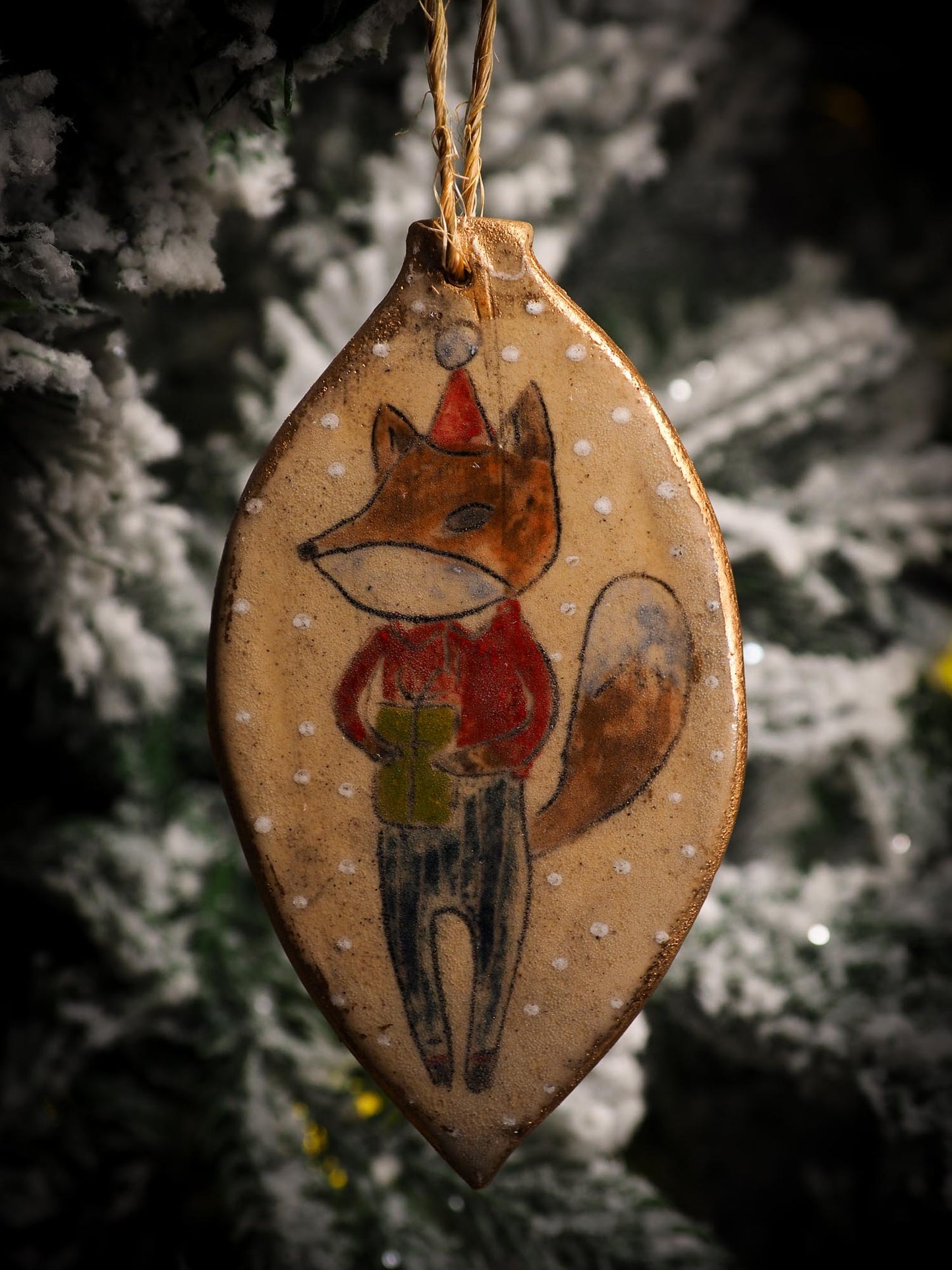 An original Christmas Holiday tree round glazed ceramic ornament handmade by Idania Salcido, the artist behind Danita Art. Glazed carved sgraffito stoneware, hand painted and decorated, it is illustrated by hand with snowmen, Christmas trees, Santa Claus, angels and snow balls and winter themes.