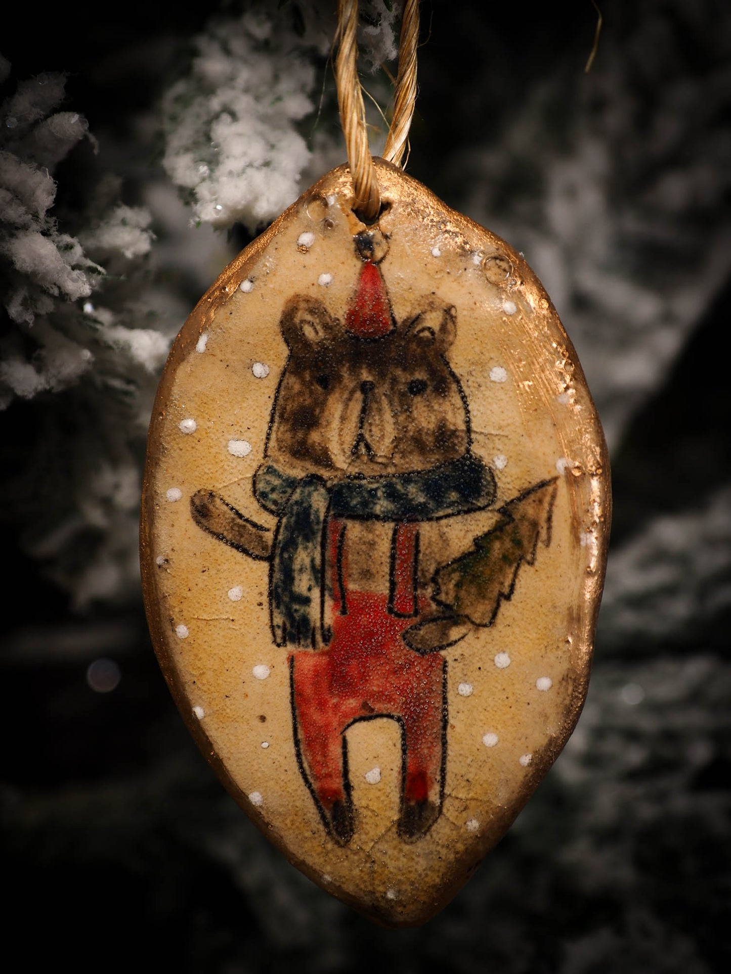 An original Christmas Holiday tree round glazed ceramic ornament handmade by Idania Salcido, the artist behind Danita Art. Glazed carved sgraffito stoneware, hand painted and decorated, it is illustrated by hand with snowmen, Christmas trees, Santa Claus, angels and snow balls and winter themes.