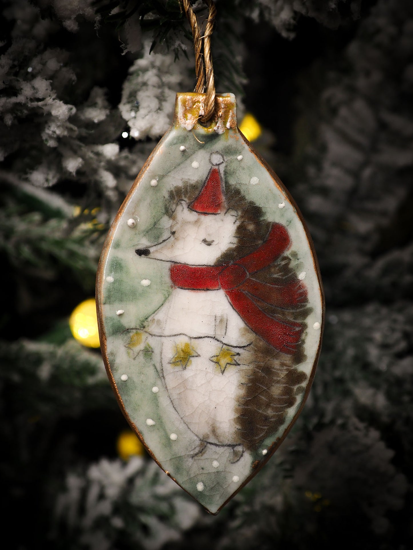 An original Christmas Holiday tree round glazed ceramic ornament handmade by Idania Salcido, the artist behind Danita Art. Glazed carved sgraffito stoneware, hand painted and decorated, it is illustrated by hand with snowmen, Christmas trees, Santa Claus, angels and snow balls and winter themes.