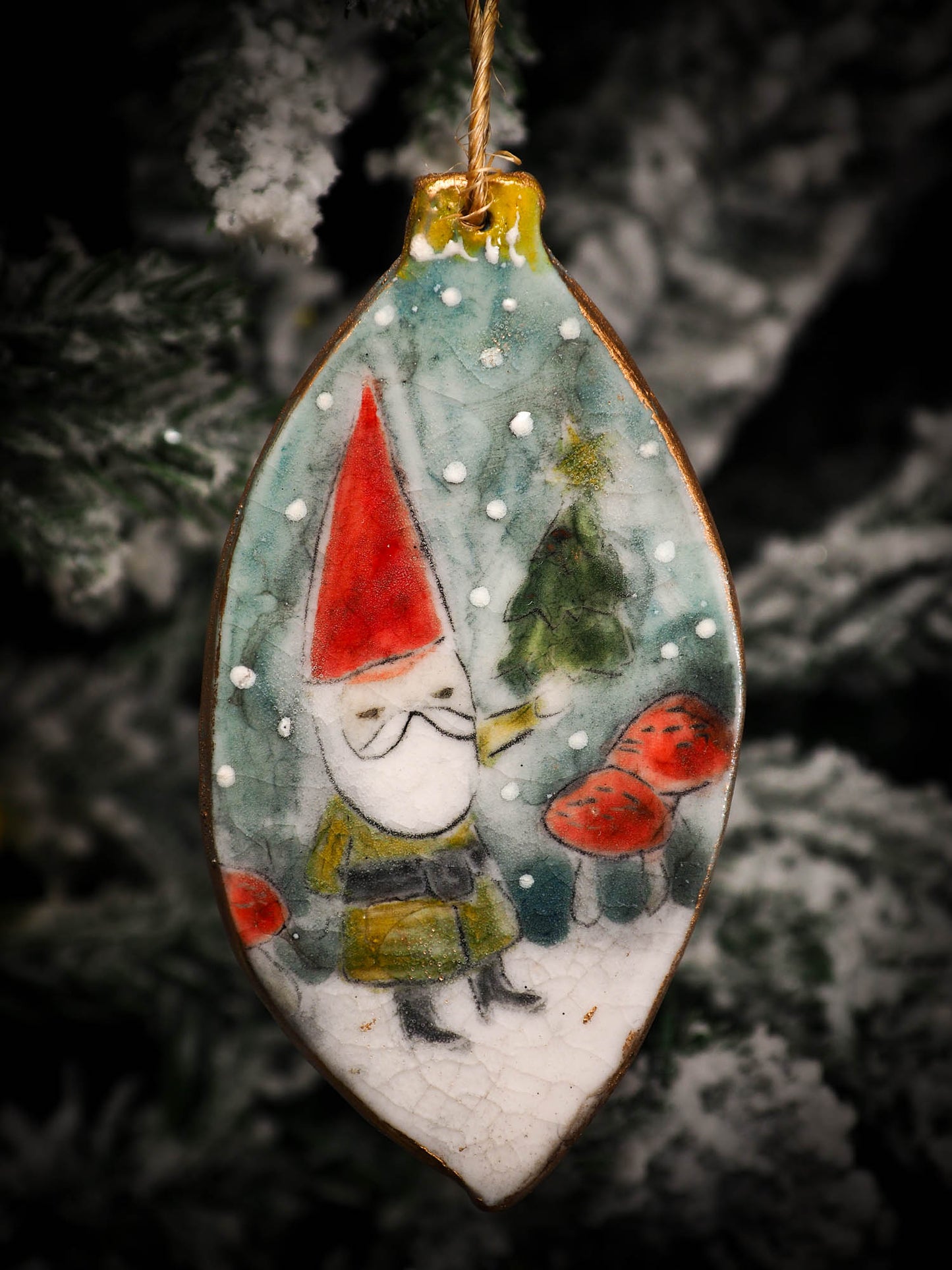 An original Christmas Holiday tree round glazed ceramic ornament handmade by Idania Salcido, the artist behind Danita Art. Glazed carved sgraffito stoneware, hand painted and decorated, it is illustrated by hand with snowmen, Christmas trees, Santa Claus, angels and snow balls and winter themes.