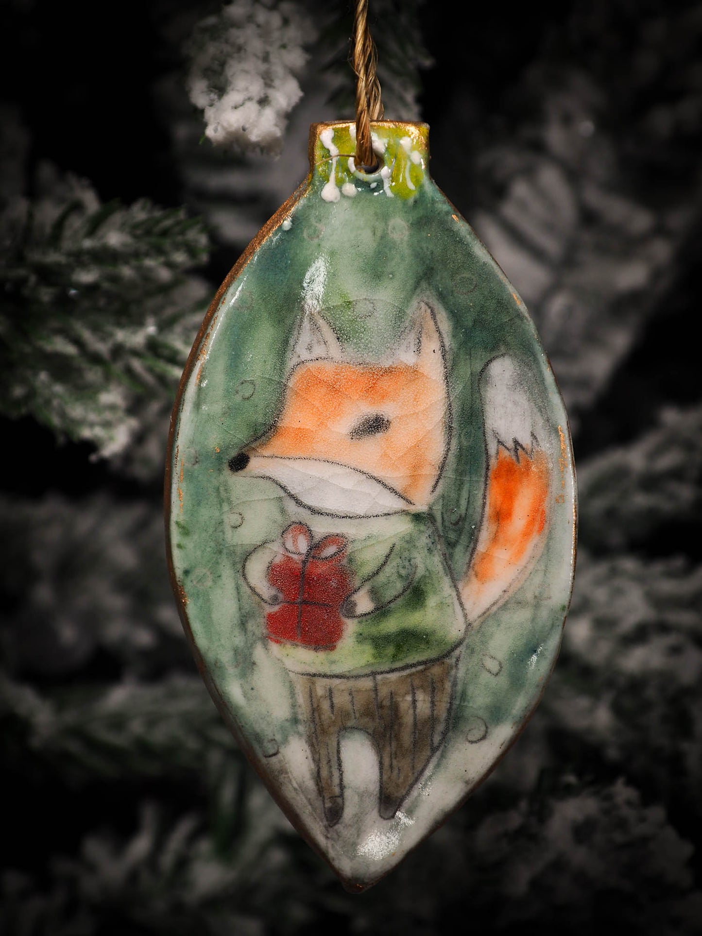 An original Christmas Holiday tree round glazed ceramic ornament handmade by Idania Salcido, the artist behind Danita Art. Glazed carved sgraffito stoneware, hand painted and decorated, it is illustrated by hand with snowmen, Christmas trees, Santa Claus, angels and snow balls and winter themes.