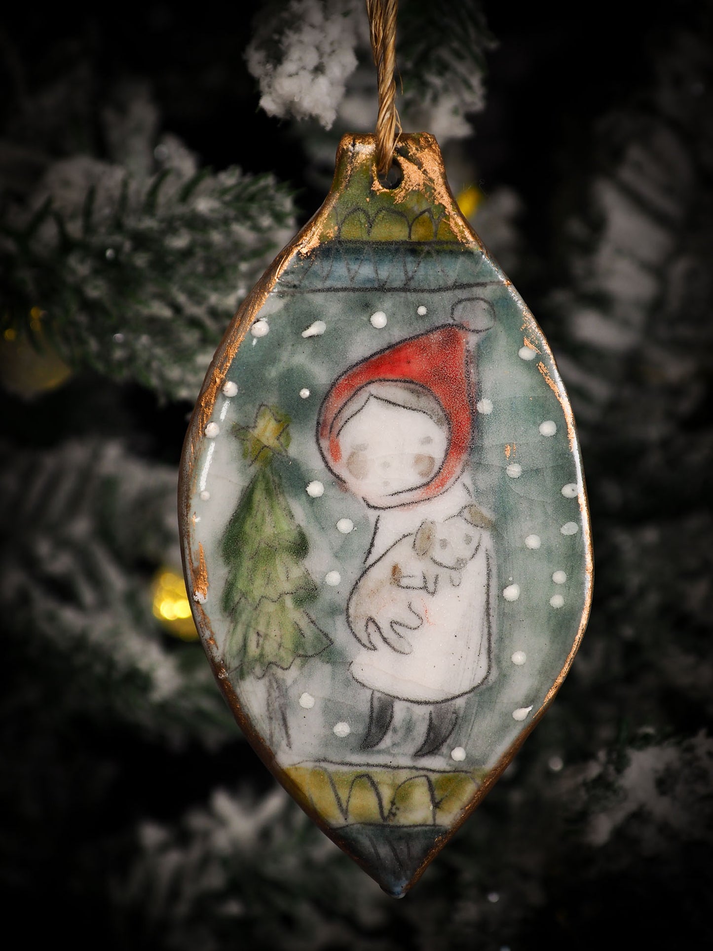 An original Christmas Holiday tree round glazed ceramic ornament handmade by Idania Salcido, the artist behind Danita Art. Glazed carved sgraffito stoneware, hand painted and decorated, it is illustrated by hand with snowmen, Christmas trees, Santa Claus, angels and snow balls and winter themes.