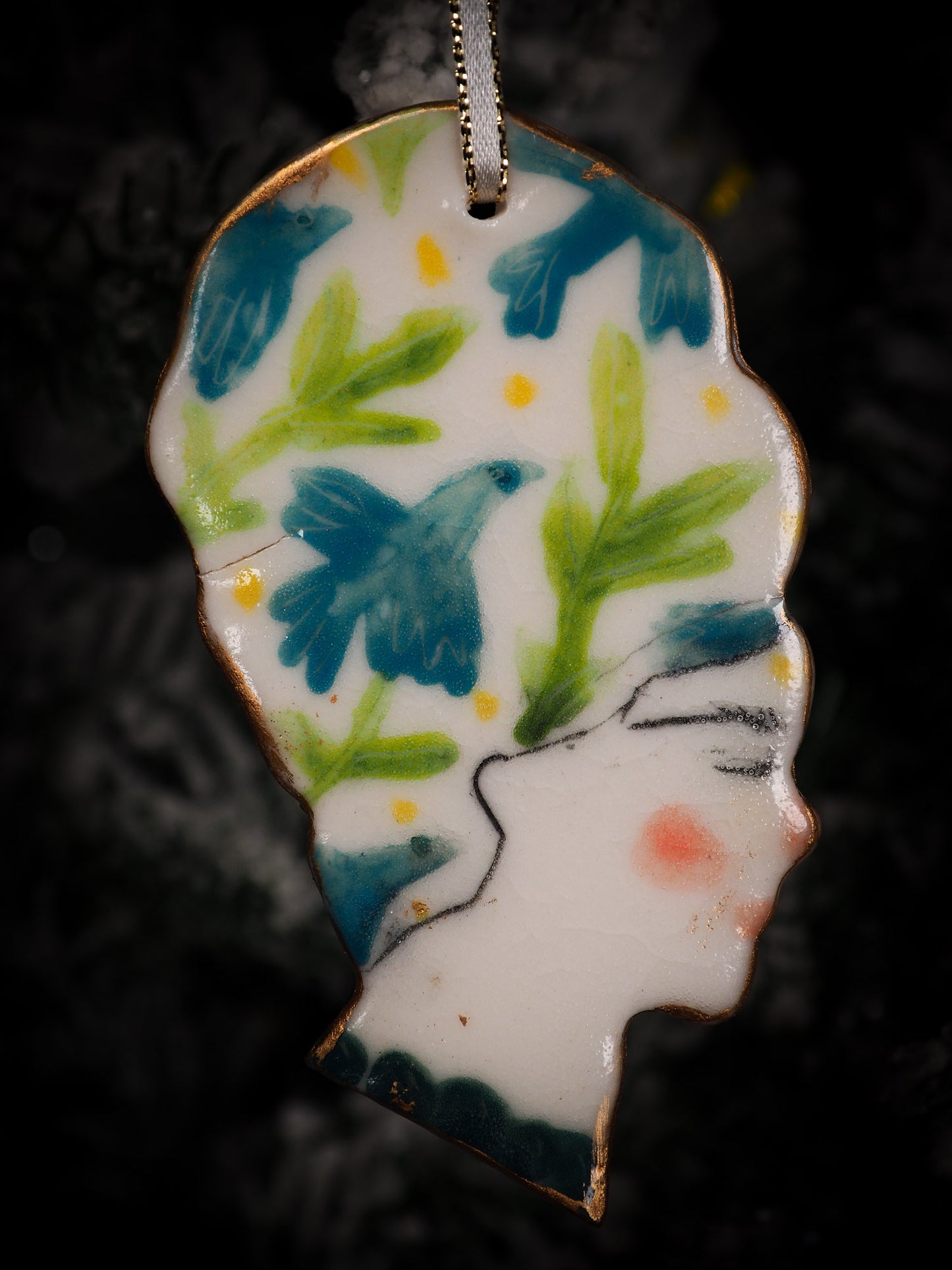 An original Christmas Holiday tree round glazed ceramic hanging ornament handmade by Idania Salcido, the artist behind Danita Art. Glazed carved sgraffito stoneware, hand painted and decorated, it is illustrated by hand with flowers, hearts, leaves, nature patterns and the face of Frida Kahlo.
