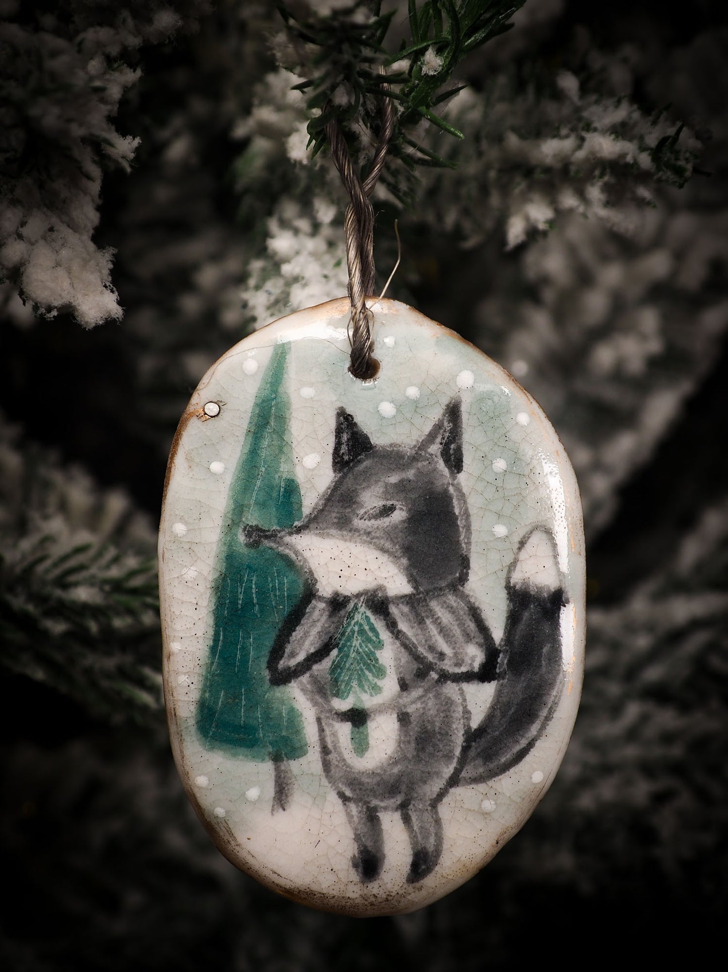An original Christmas Holiday tree round glazed ceramic ornament handmade by Idania Salcido, the artist behind Danita Art. Glazed carved sgraffito stoneware, hand painted and decorated, it is illustrated by hand with snowmen, Christmas trees, Santa Claus, angels and snow balls and winter themes.