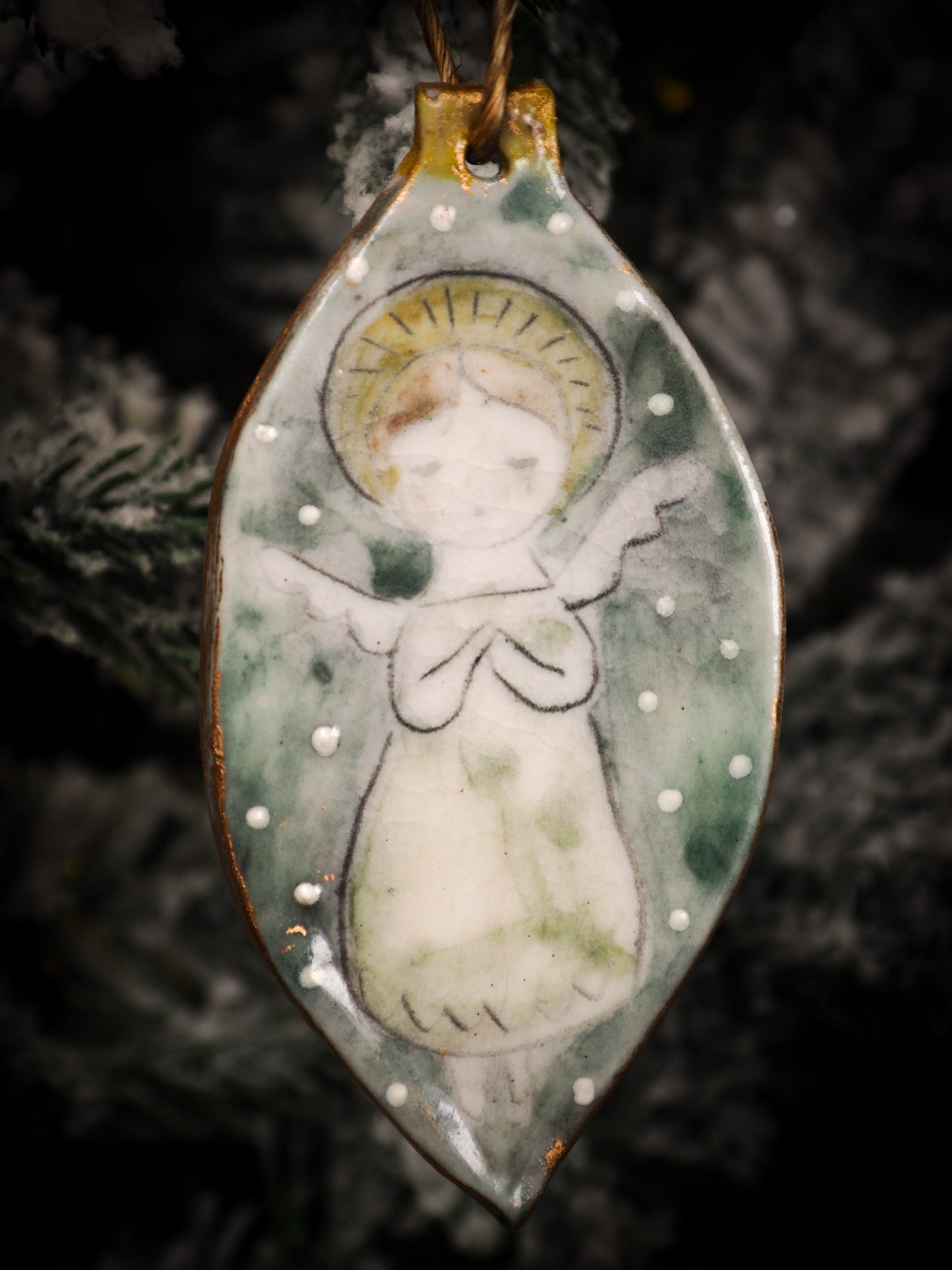 An original Christmas Holiday tree round glazed ceramic ornament handmade by Idania Salcido, the artist behind Danita Art. Glazed carved sgraffito stoneware, hand painted and decorated, it is illustrated by hand with snowmen, Christmas trees, Santa Claus, angels and snow balls and winter themes.