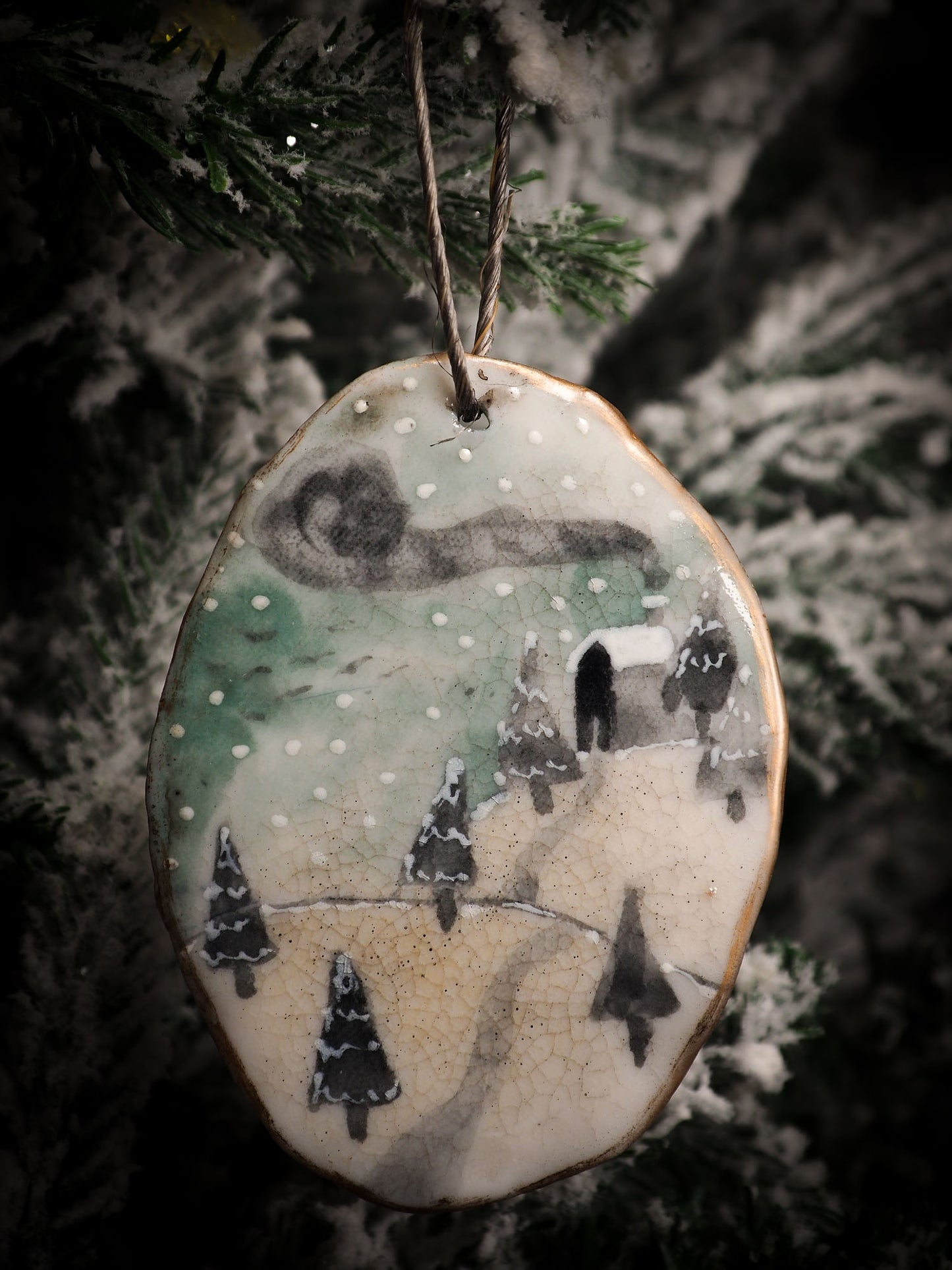 An original Christmas Holiday tree round glazed ceramic ornament handmade by Idania Salcido, the artist behind Danita Art. Glazed carved sgraffito stoneware, hand painted and decorated, it is illustrated by hand with snowmen, Christmas trees, Santa Claus, angels and snow balls and winter themes.