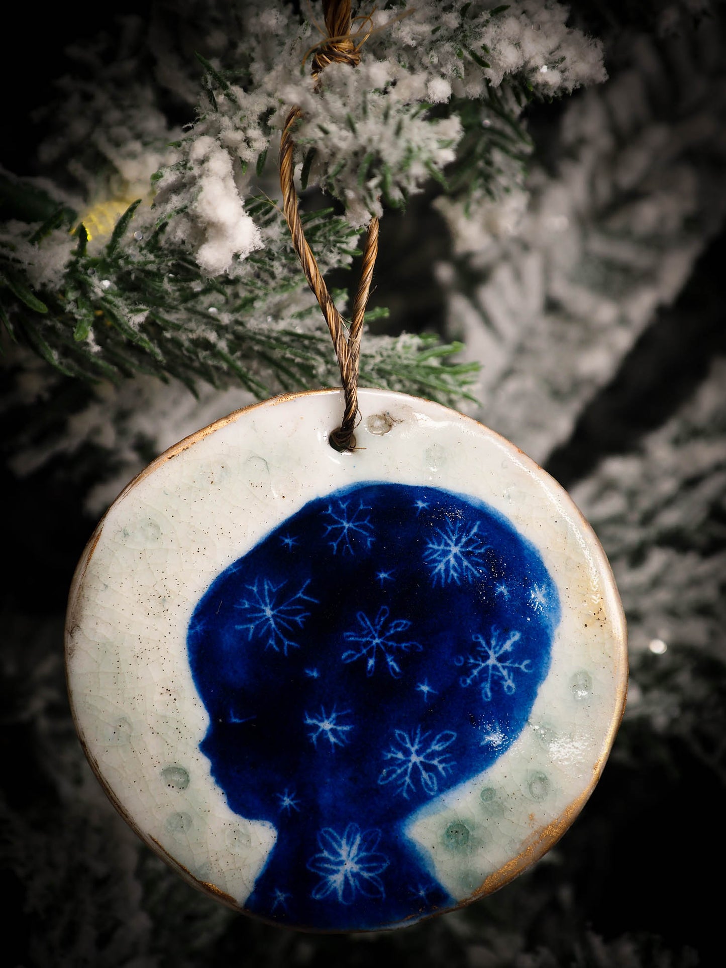 An original Christmas Holiday tree round glazed ceramic ornament handmade by Idania Salcido, the artist behind Danita Art. Glazed carved sgraffito stoneware, hand painted and decorated, it is illustrated by hand with snowmen, Christmas trees, Santa Claus, angels and snow balls and winter themes.