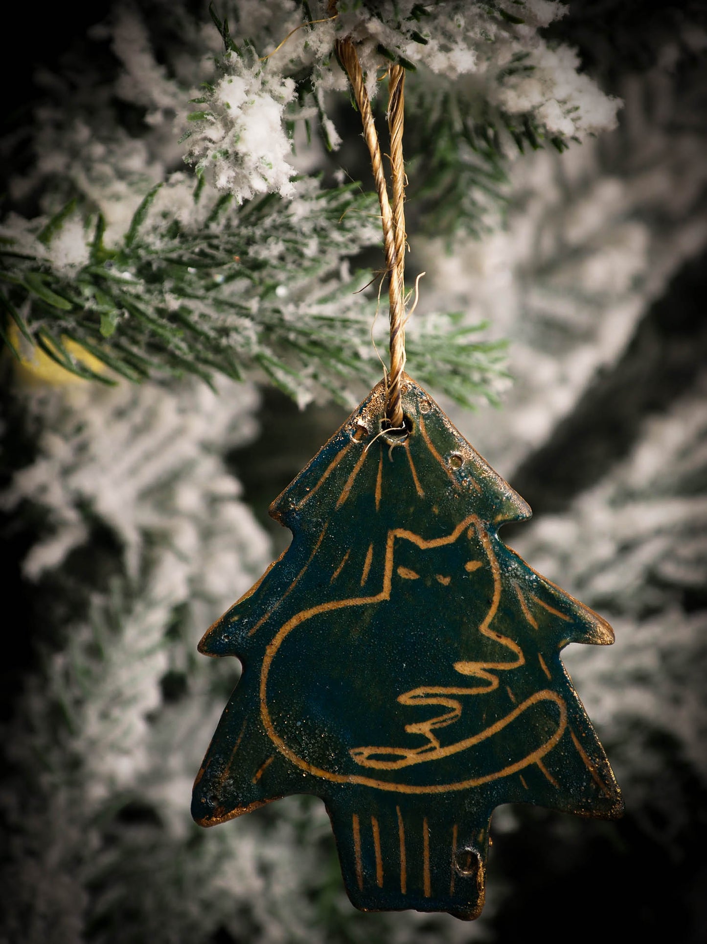 An original Christmas Holiday tree round glazed ceramic ornament handmade by Idania Salcido, the artist behind Danita Art. Glazed carved sgraffito stoneware, hand painted and decorated, it is illustrated by hand with snowmen, Christmas trees, Santa Claus, angels and snow balls and winter themes.