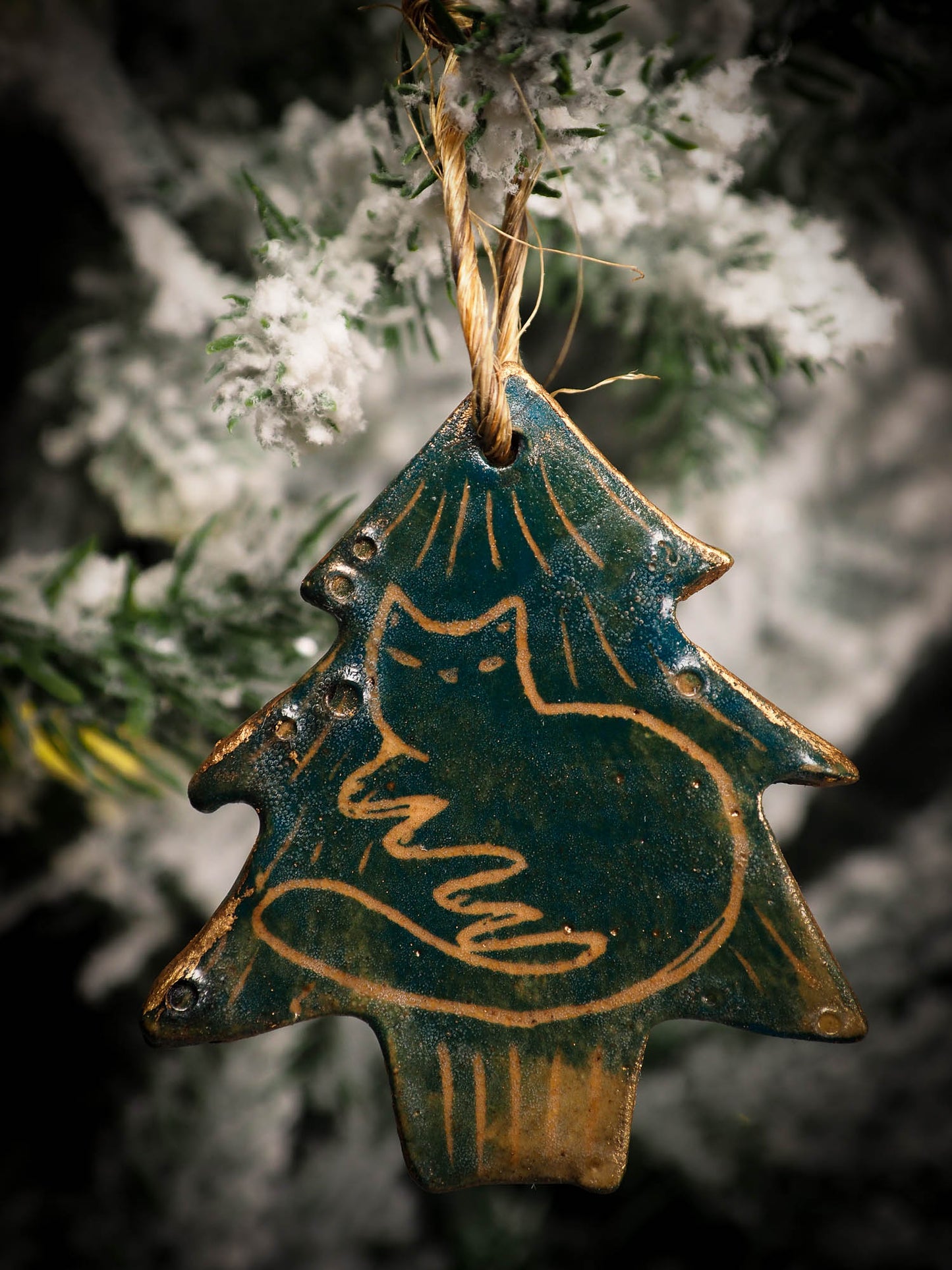 An original Christmas Holiday tree round glazed ceramic ornament handmade by Idania Salcido, the artist behind Danita Art. Glazed carved sgraffito stoneware, hand painted and decorated, it is illustrated by hand with snowmen, Christmas trees, Santa Claus, angels and snow balls and winter themes.