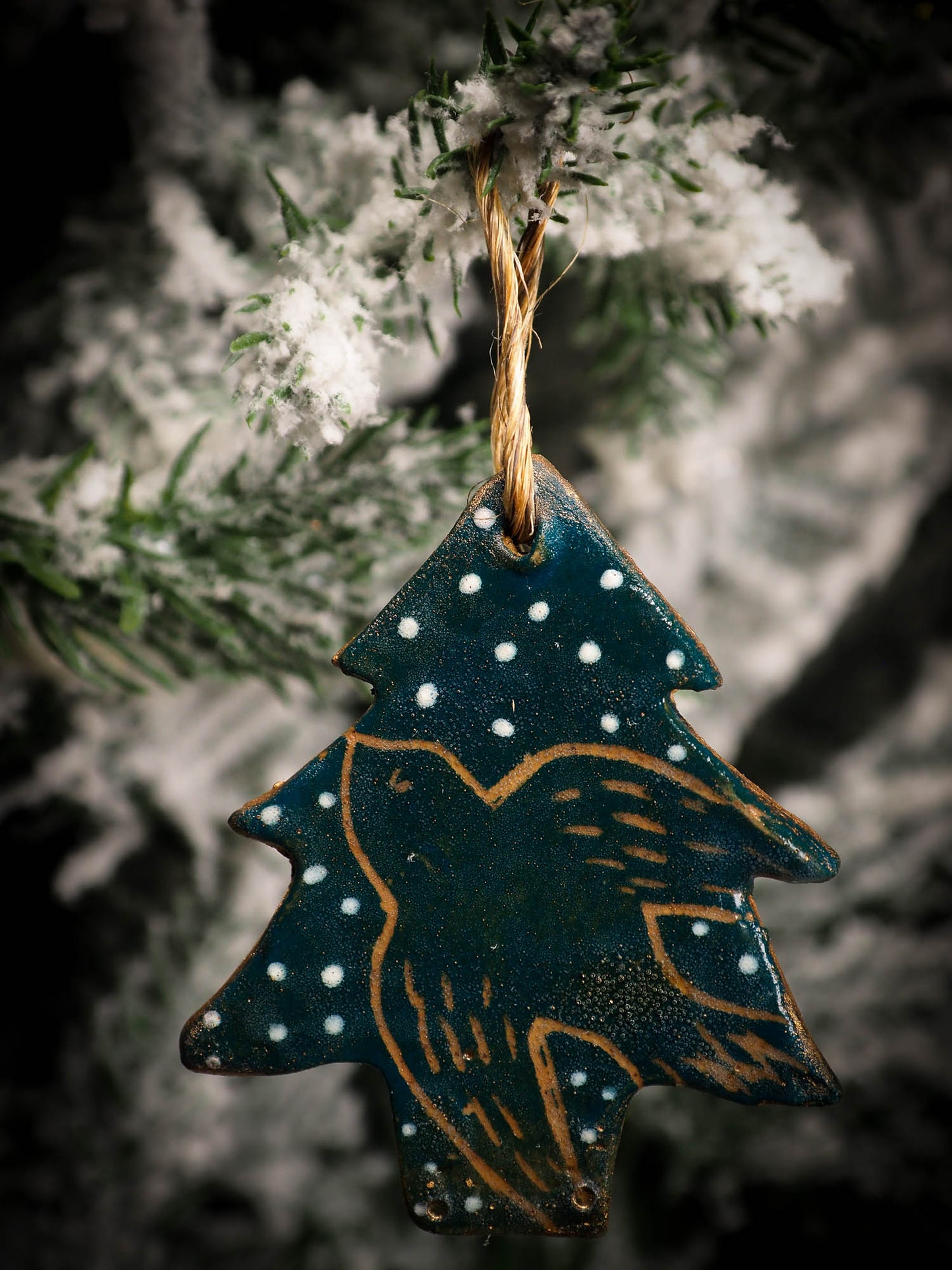 An original Christmas Holiday tree round glazed ceramic ornament handmade by Idania Salcido, the artist behind Danita Art. Glazed carved sgraffito stoneware, hand painted and decorated, it is illustrated by hand with snowmen, Christmas trees, Santa Claus, angels and snow balls and winter themes.