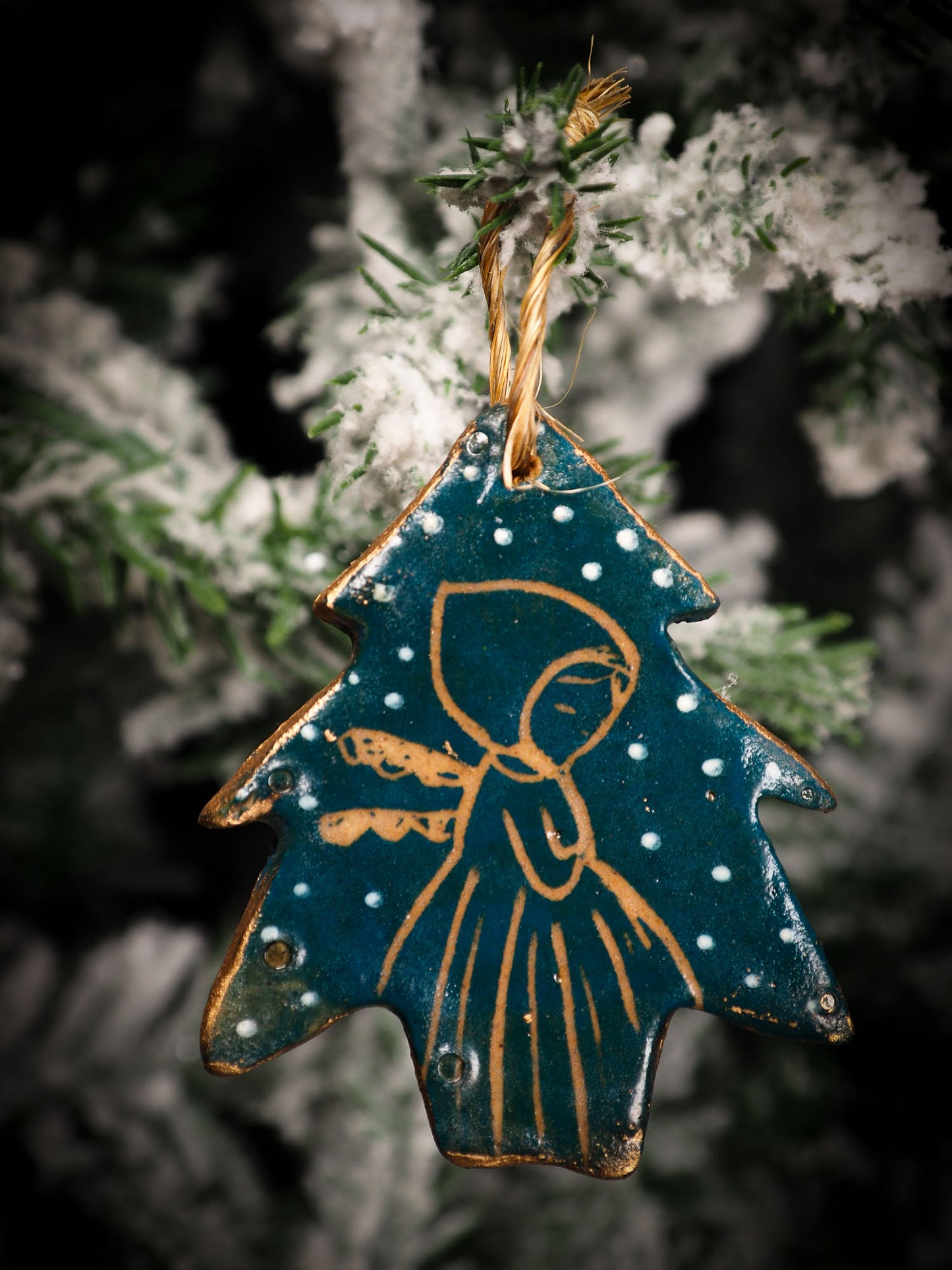 An original Christmas Holiday tree round glazed ceramic ornament handmade by Idania Salcido, the artist behind Danita Art. Glazed carved sgraffito stoneware, hand painted and decorated, it is illustrated by hand with snowmen, Christmas trees, Santa Claus, angels and snow balls and winter themes.