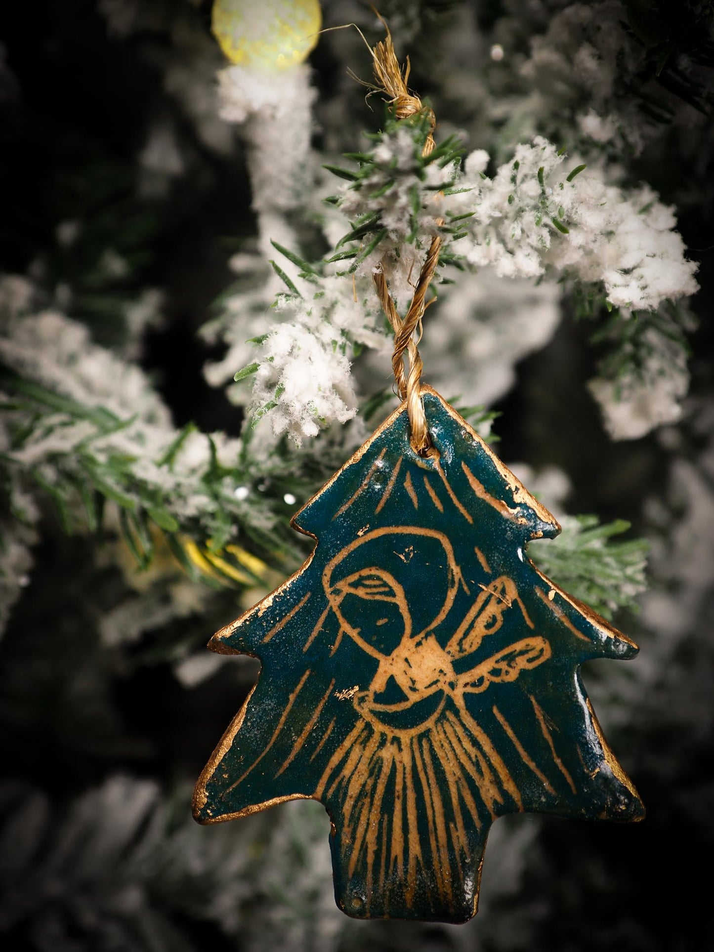 An original Christmas Holiday tree round glazed ceramic ornament handmade by Idania Salcido, the artist behind Danita Art. Glazed carved sgraffito stoneware, hand painted and decorated, it is illustrated by hand with snowmen, Christmas trees, Santa Claus, angels and snow balls and winter themes.