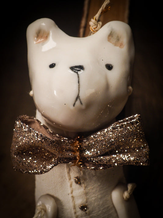 An adorable hand made porcelain and fabric fine art doll by Idania Salcido Danita Art. Perfect to hang as a delicate Christmas tree ornament, this fired ceramic mixed media artwork is unique. Each doll has a beautiful hand sculpted porcelain ceramic face and hand dyed fabric body with vintage accessories as home decor.