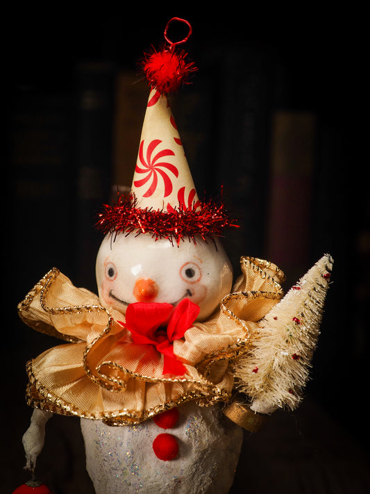 An adorable hand made porcelain and fabric fine art doll by Idania Salcido Danita Art. Perfect to hang as a delicate Christmas tree ornament, this fired ceramic mixed media artwork is unique. Each doll has a beautiful hand sculpted porcelain ceramic face and hand dyed fabric body with vintage accessories as home decor.