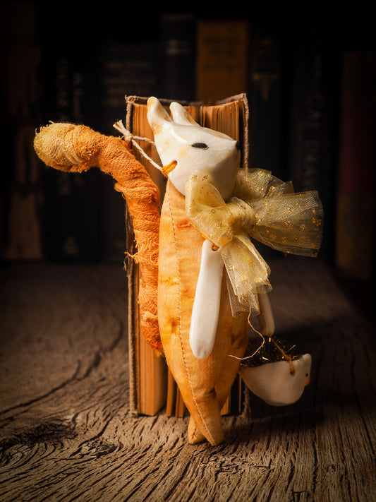 An adorable hand made porcelain and fabric fine art doll by Idania Salcido Danita Art. Perfect to hang as a delicate Christmas tree ornament, this fired ceramic mixed media artwork is unique. Each doll has a beautiful hand sculpted porcelain ceramic face and hand dyed fabric body with vintage accessories as home decor.